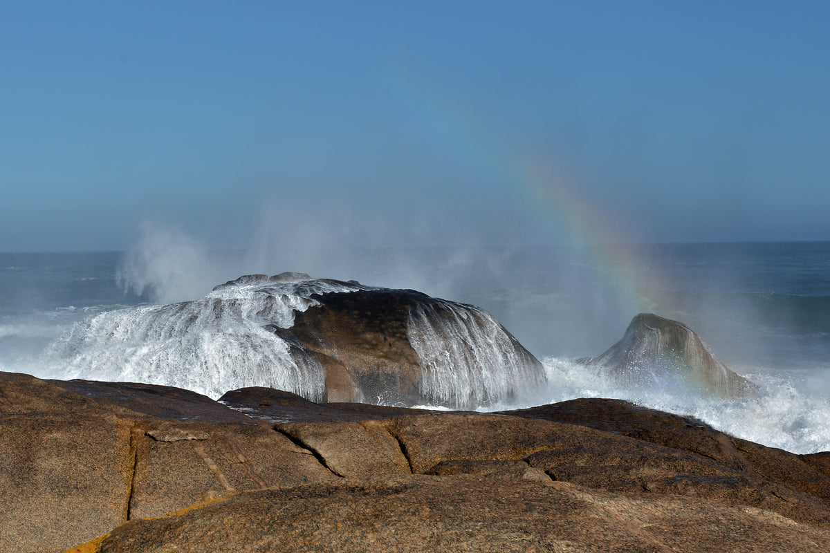Ocean Symphony: Waves and Rainbow Over Granite